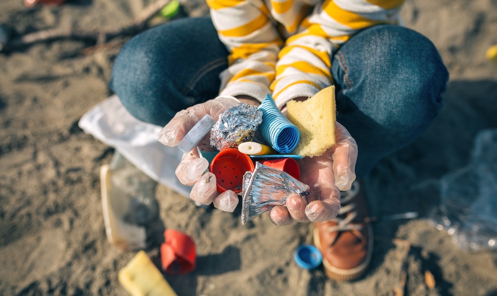 Volunteer collecting trash on the beach